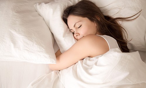 Woman soundly sleeping thanks to sleep apnea treatment in Vienna