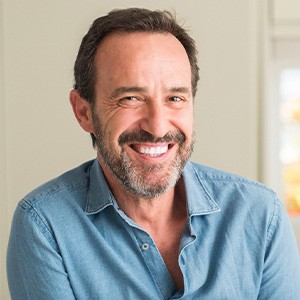 Man in denim shirt smiling