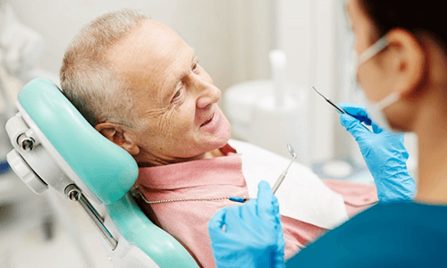 a patient with dentures visiting his dentist