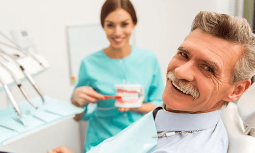 a patient smiling after receiving his dentures in Vienna