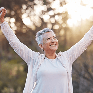 a woman with dentures enjoying a healthy smile