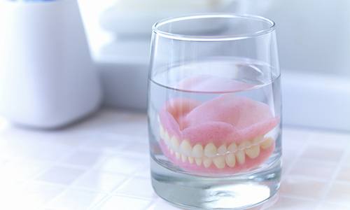 closeup of soaking dentures in Vienna 