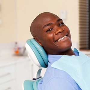 man smiling after paying for dentures in Vienna 