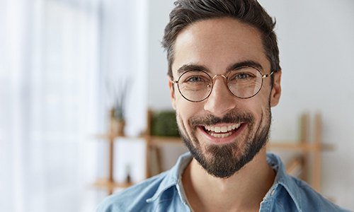 Man replaced a missing tooth with an implant-retained bridge.