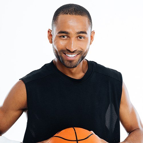 Smiling man holding a basketball