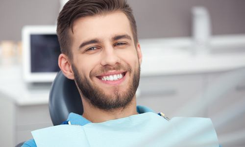 man smiling in dentist chair