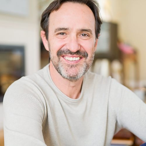 Man smiling with a single tooth dental implant in Vienna