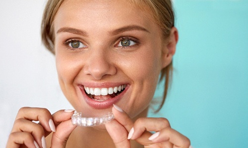 Woman with whitening tray