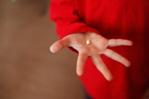 A child holding a tooth.