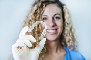 dentist holding invisalign tray